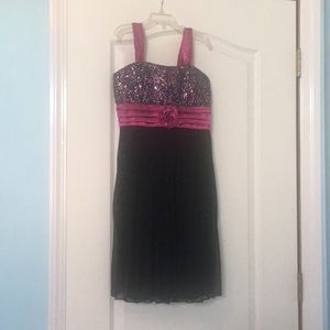 A black and fuschia dress with colorful sequins.